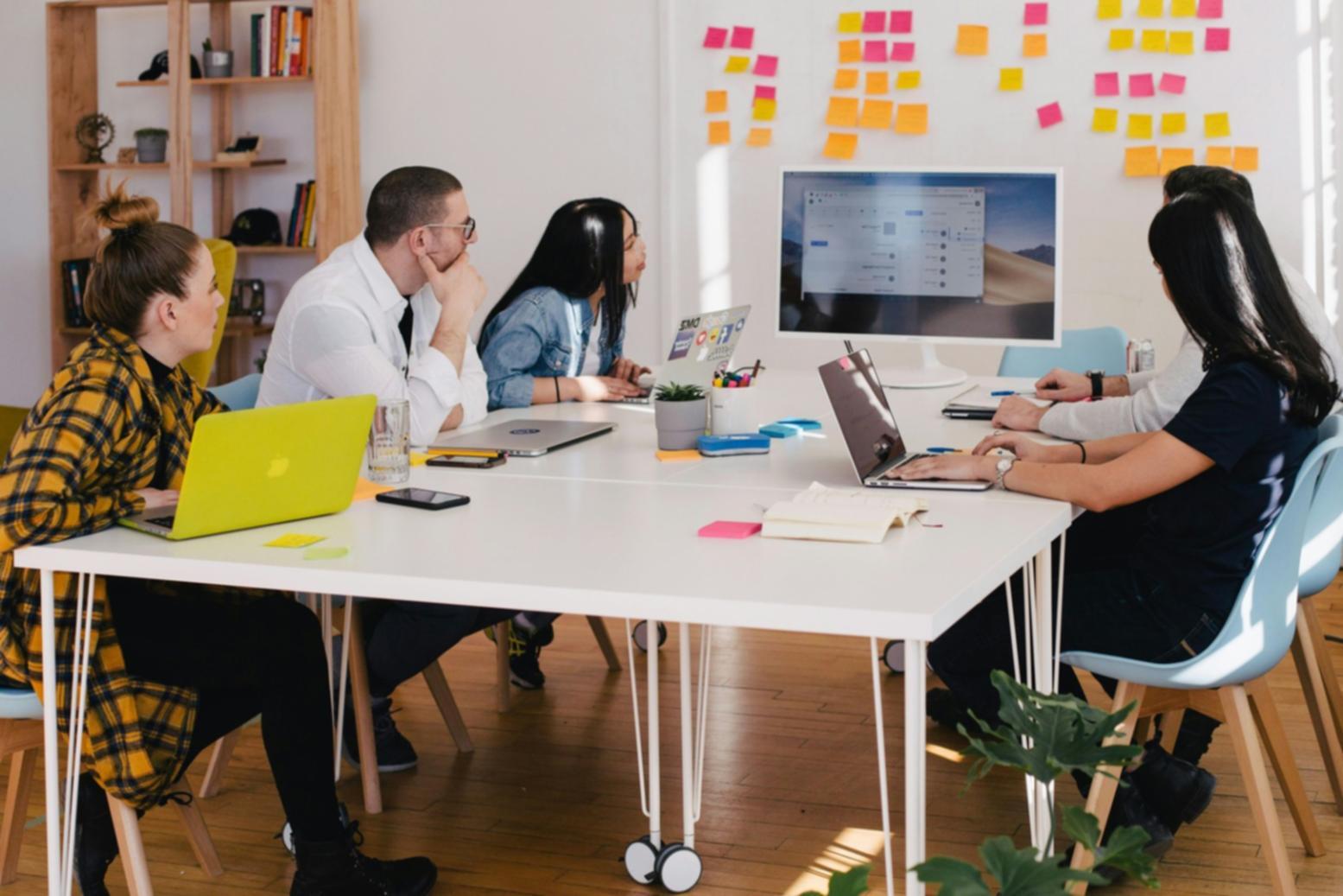 Organized workspace showing keyword research tools, notebooks, and computer setup