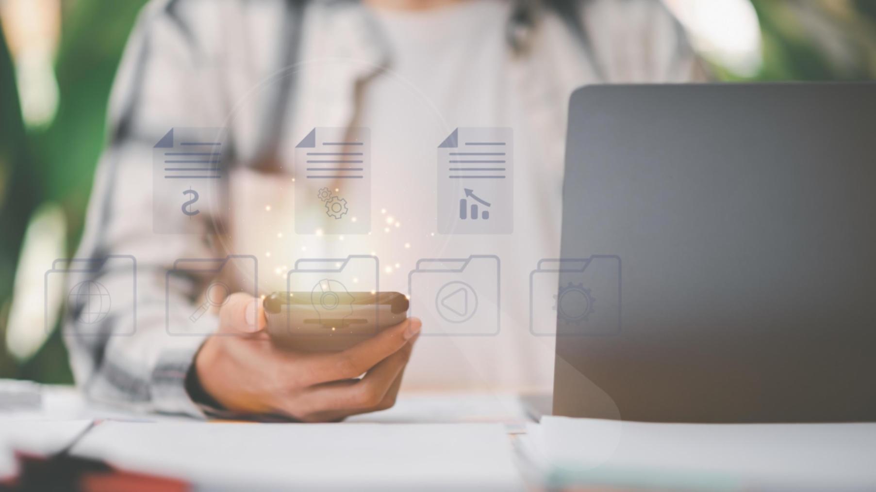 Student analyzing keyword research data on laptop screen showing search volume metrics and competition levels